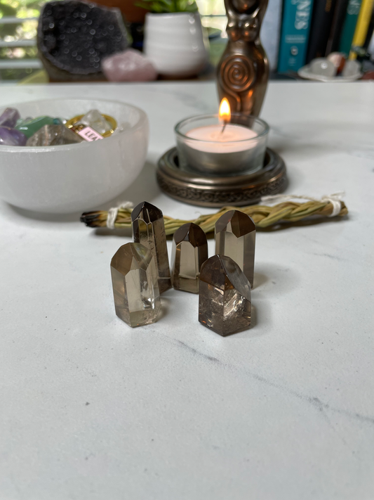 Size 1 Mini Smoky Quartz Towers arranged on a white marble surface